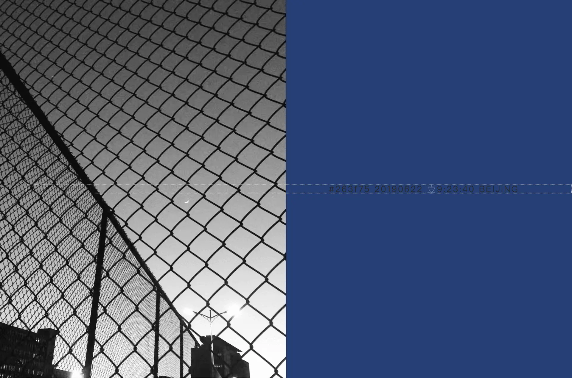 Spread — chain-link fence, smog grey vs blue sky