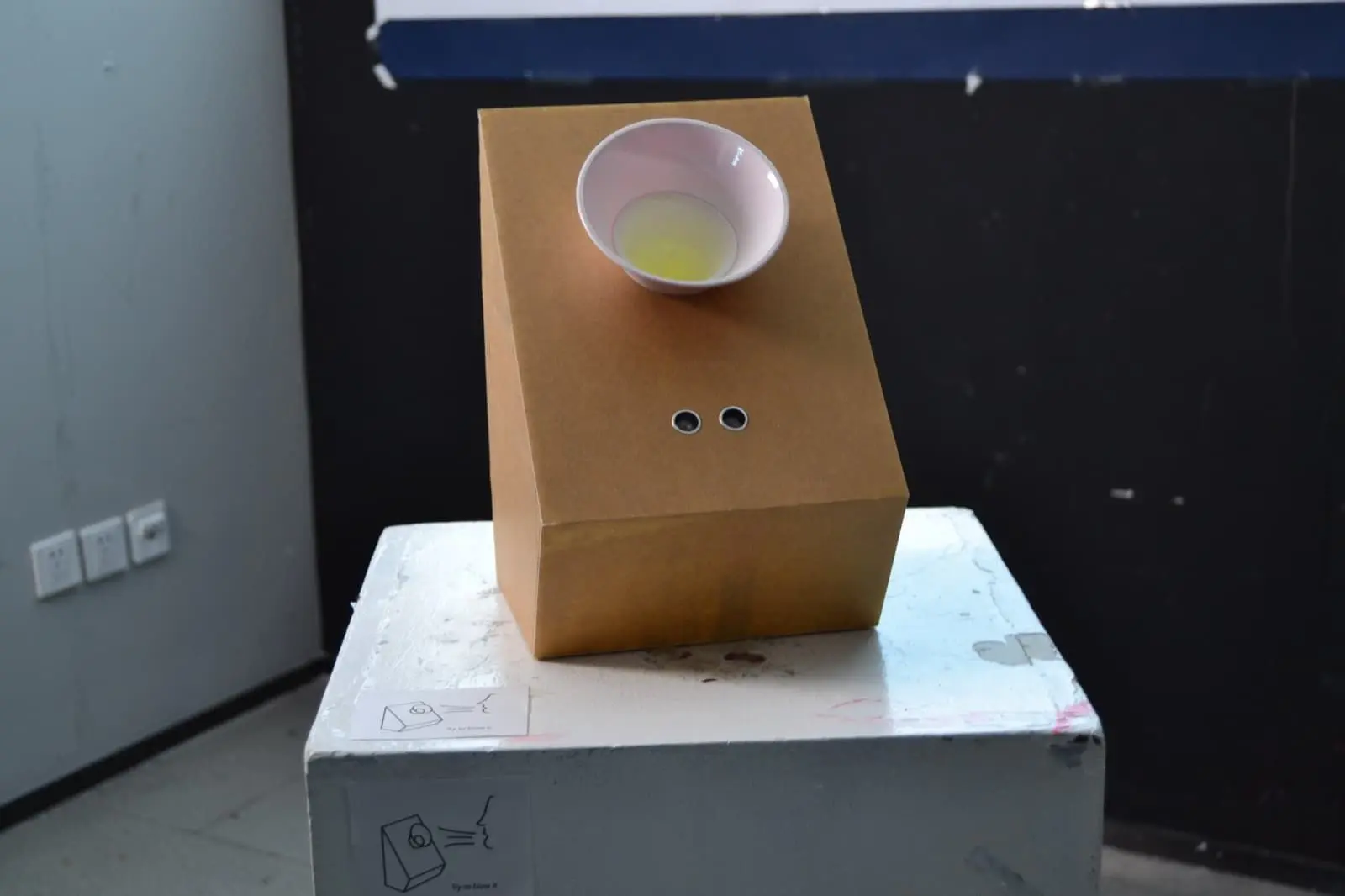 The Waiting for Wind device — a cardboard box with a bowl-shaped air intake and two sensor holes