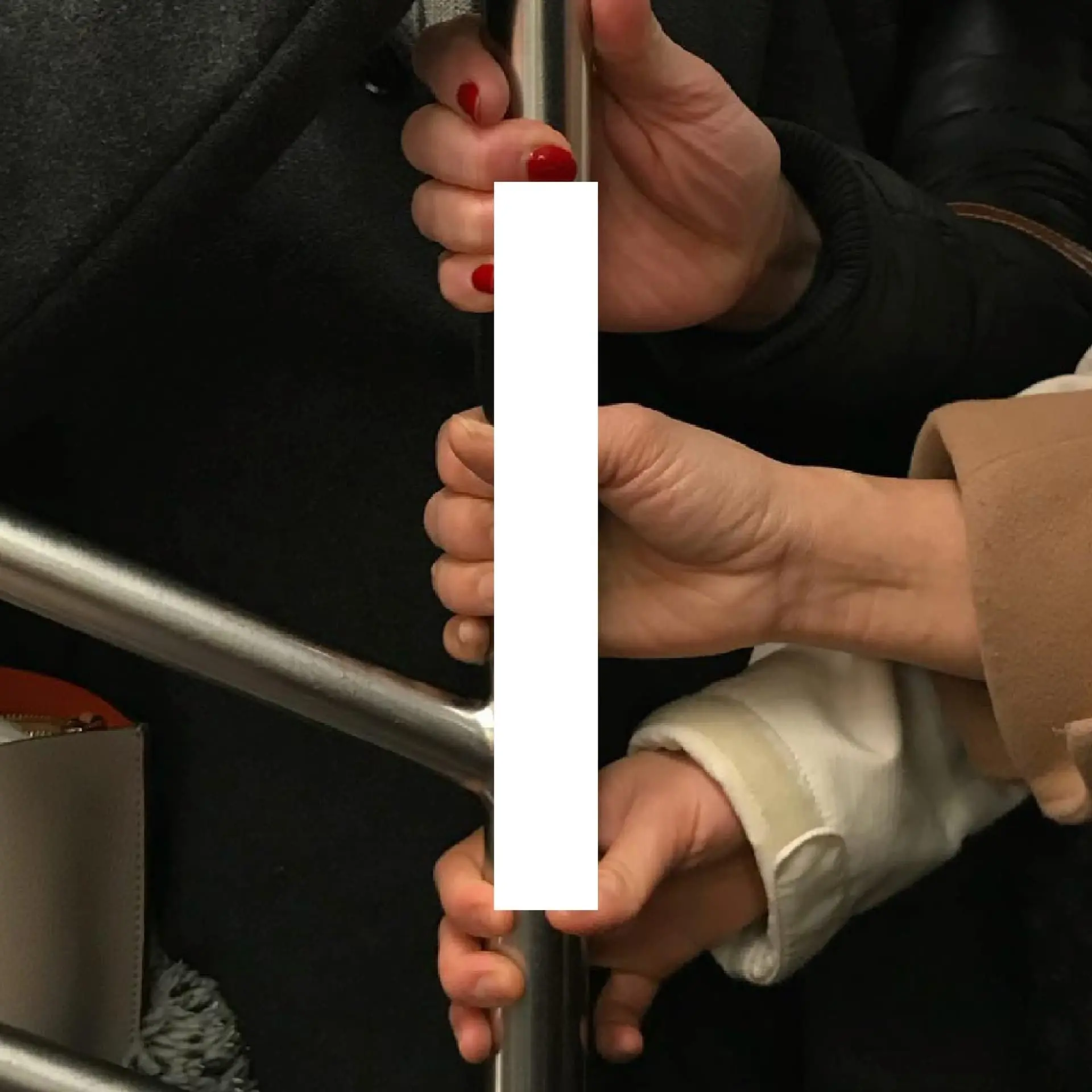 Book spread — multiple hands, red nails