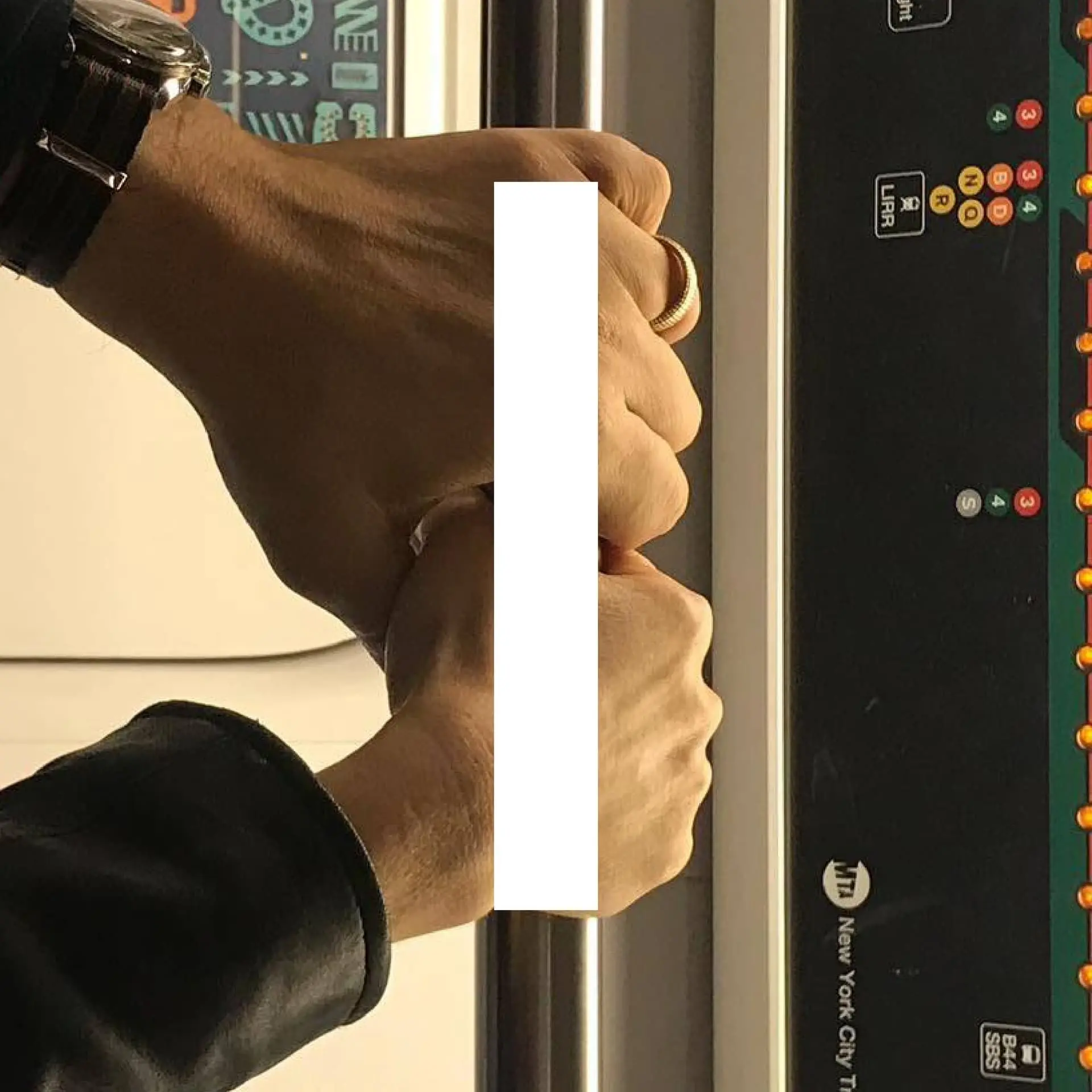 Book spread — two hands, watch