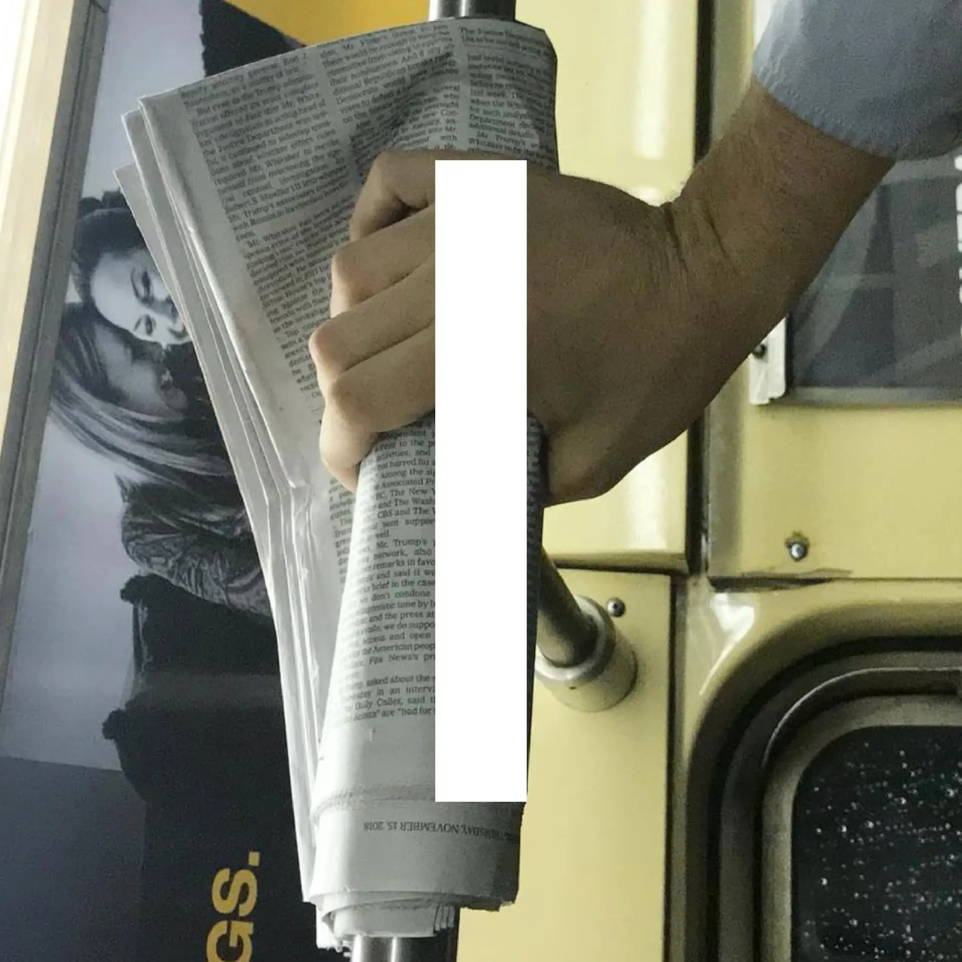 Book spread — hand with newspaper